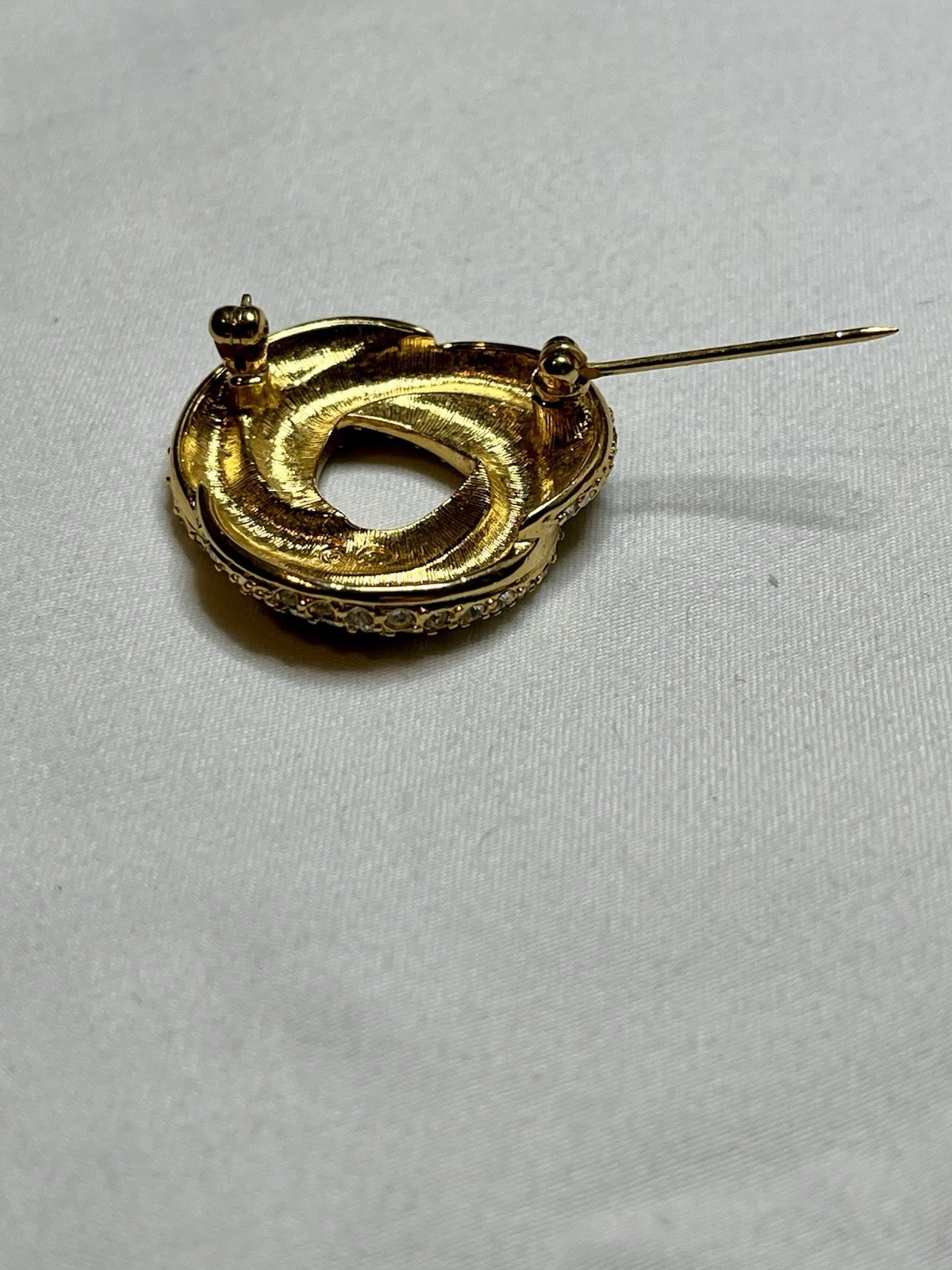 Signed Swarovski Gold Tone Clear Crystal Black Enamel Love Knot Brooch Pin
