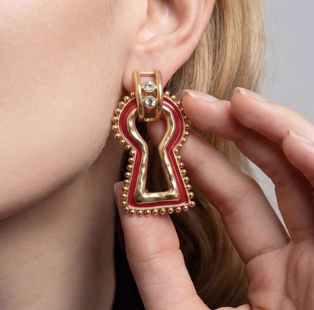 Surrealist, Schiaparelli style, keyhole stud earrings, gold with red enamel