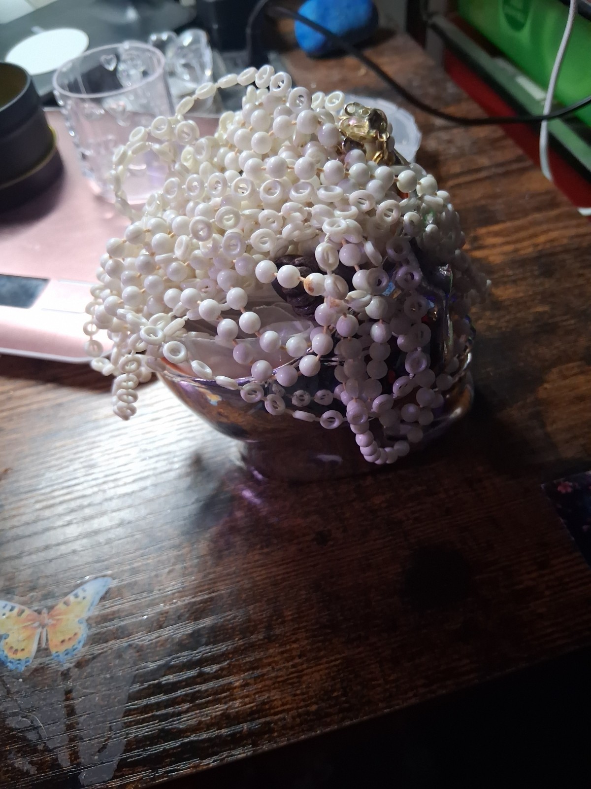 Skull Head With about 6 Pieces Of Jewelry With A White Necklace On Top