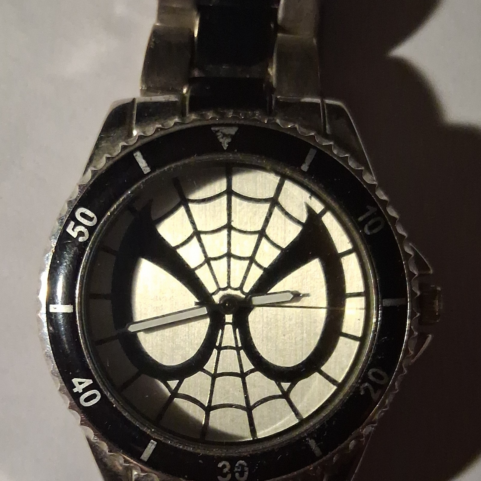 Marvel Men’s Analog Wristwatch Spiderweb Dial Black Fixed Bezel Silver Bracelet