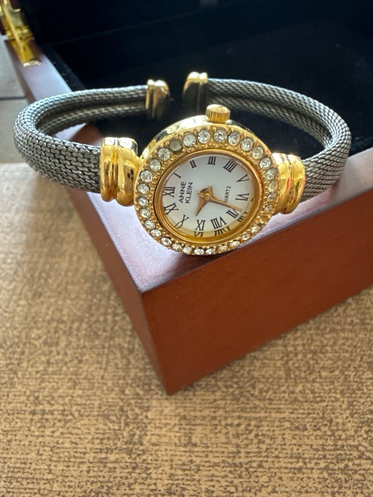 Anne Klein Women’s Quartz Dress Watch Gold Case Silver Bangle White Roman Dial