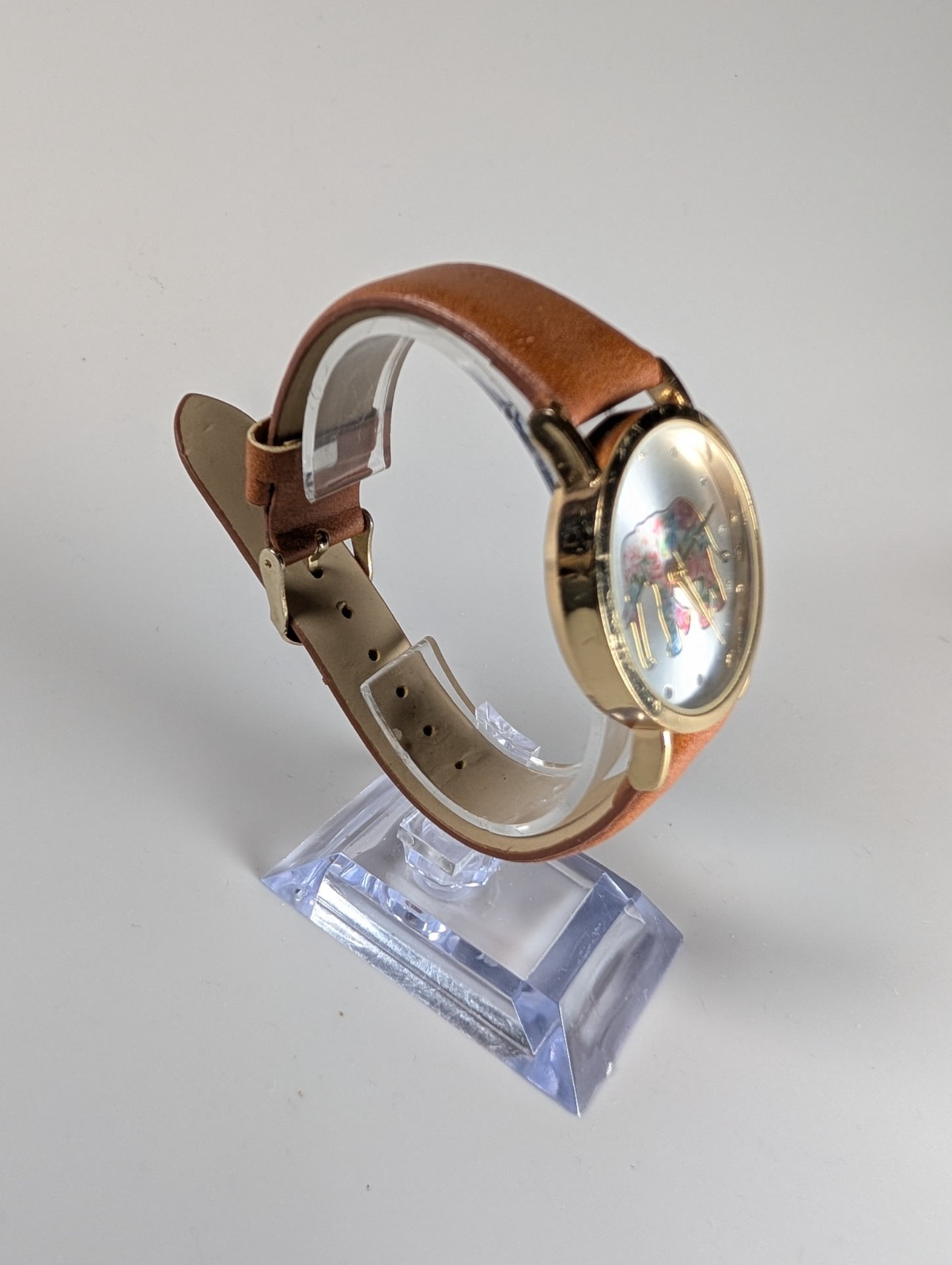 Elephant watch with flower pattern and gold outline and dot indexes brown band