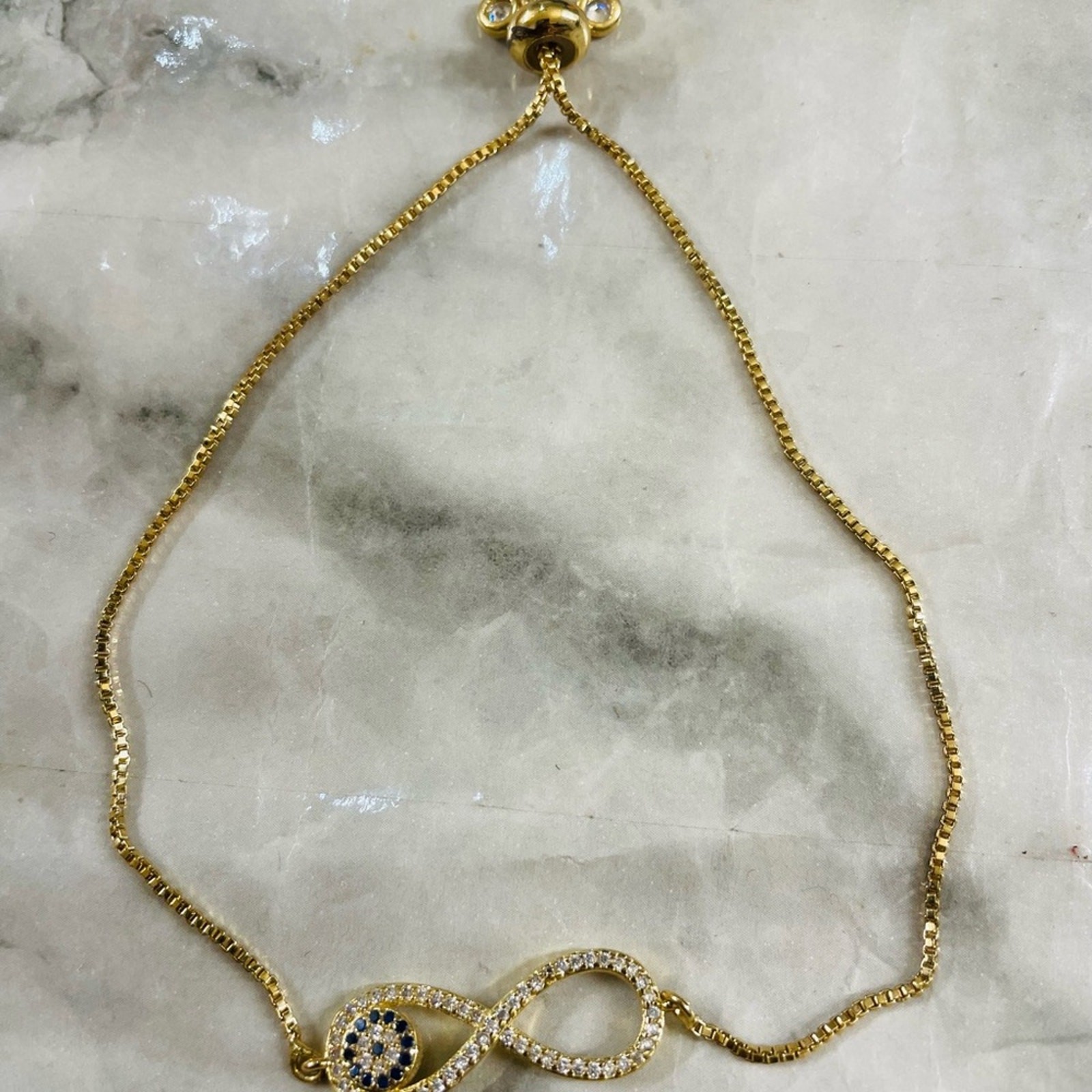 9.5in Oro laminado 18K Gold Infinity Evil Eye Bracelet w/ Clear and Black Stone