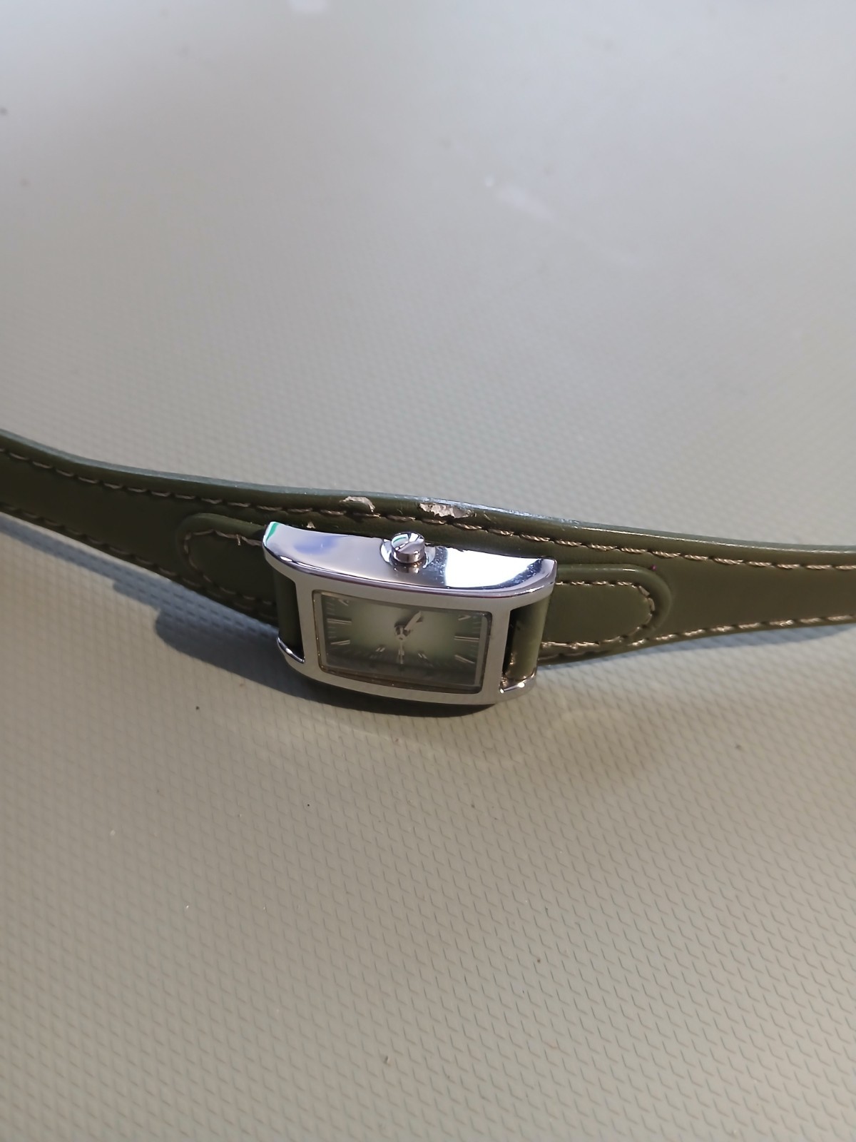 Ladies silver wathch with green face and one piece strap, new battery