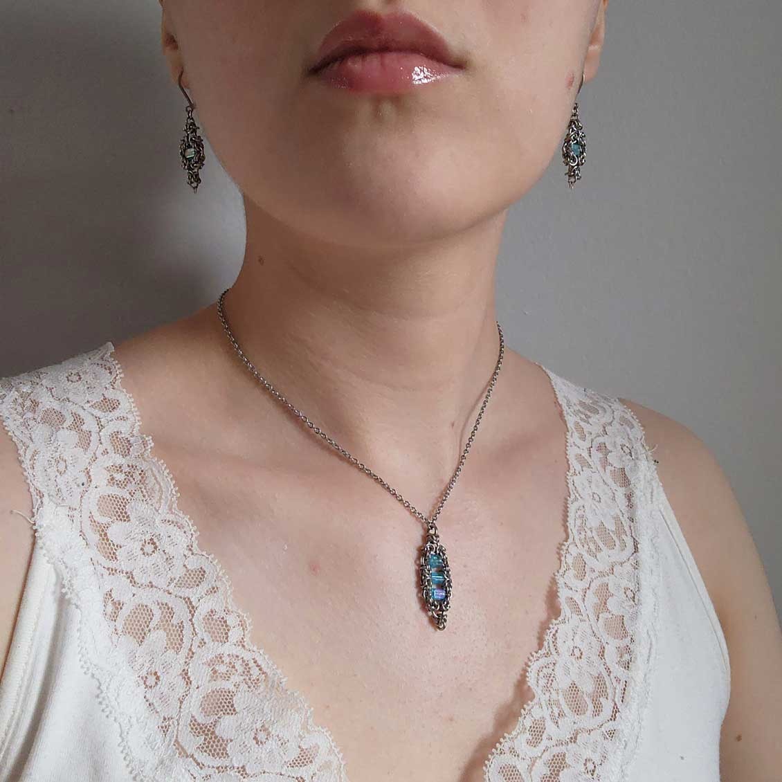 Silver and teal dangly lever back earrings made of stainless steel