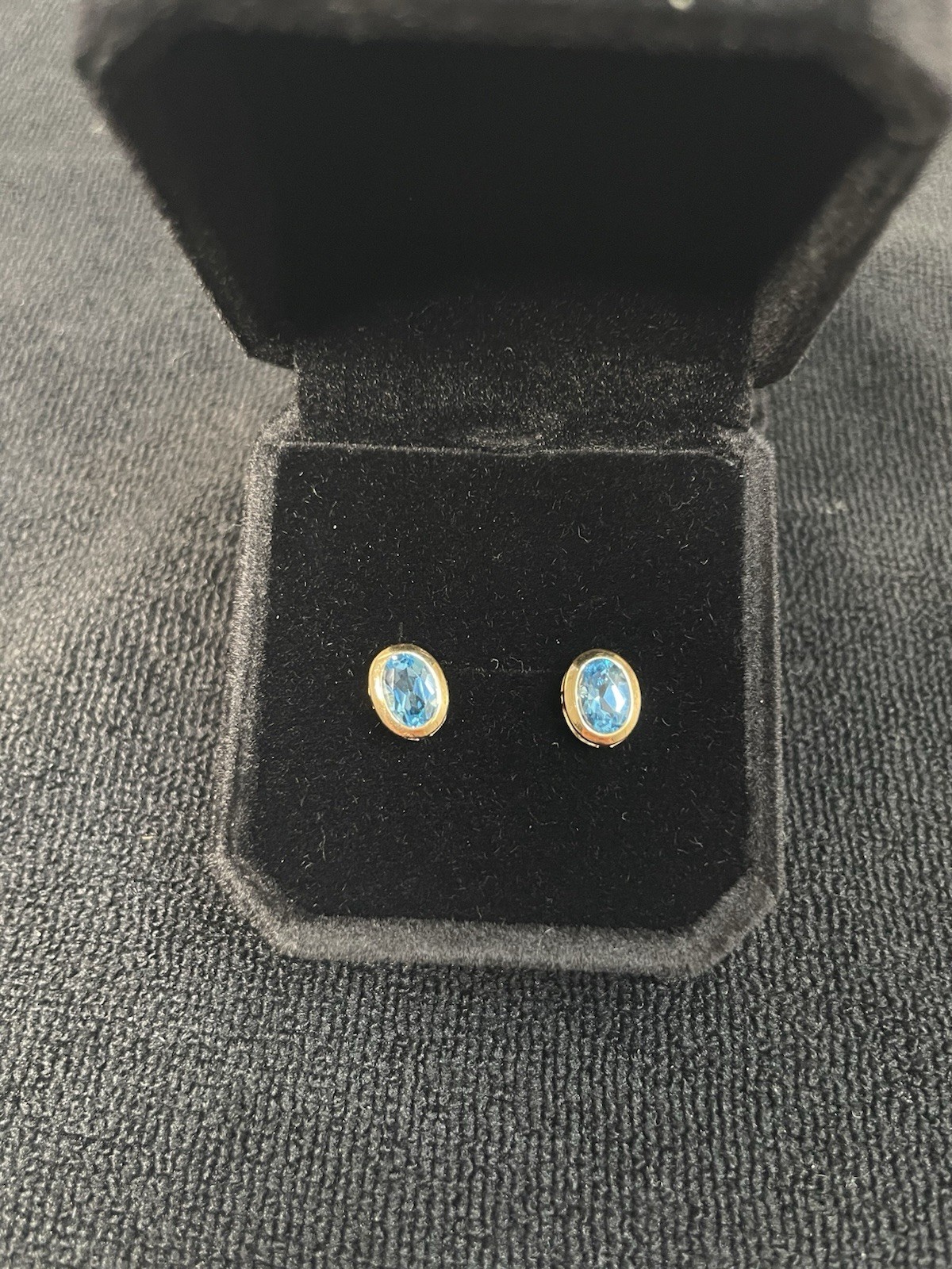 14k yellow gold oval blue topaz stud earrings. no clutch