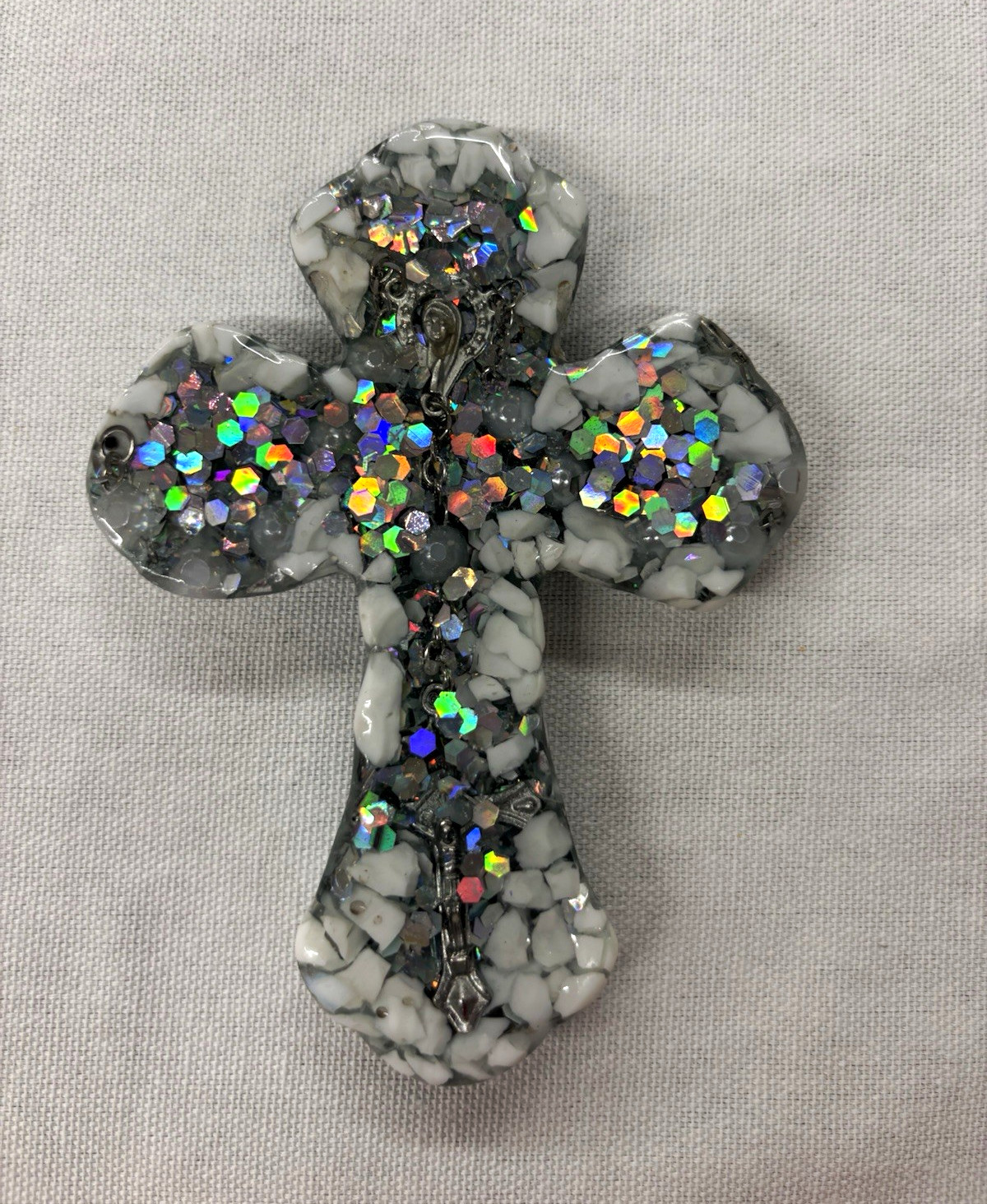 Handmade resin cross made with a real rosary in the center and sparkling glitter