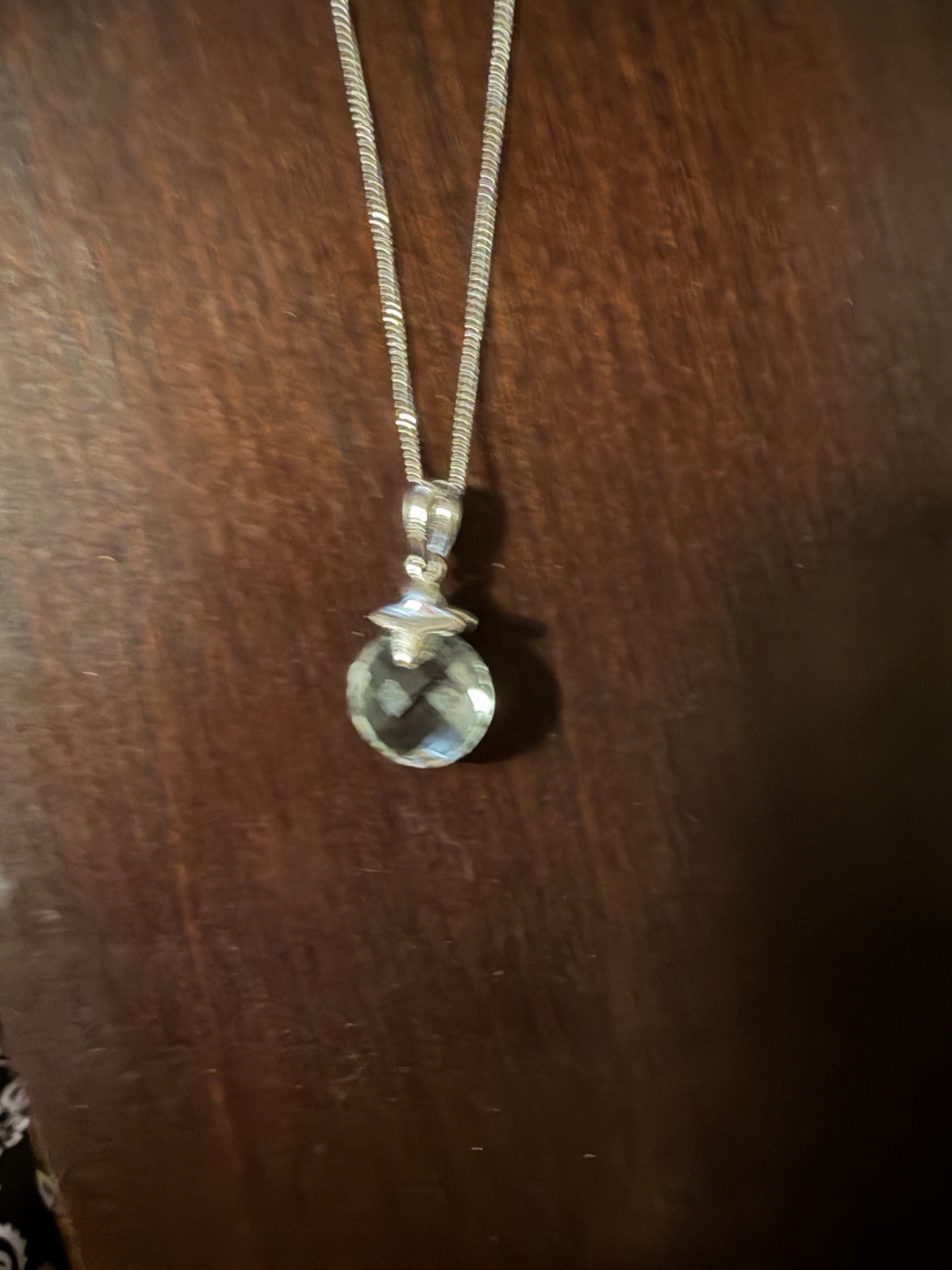 Sterling Silver and Green Amethyst pendant on a chain.