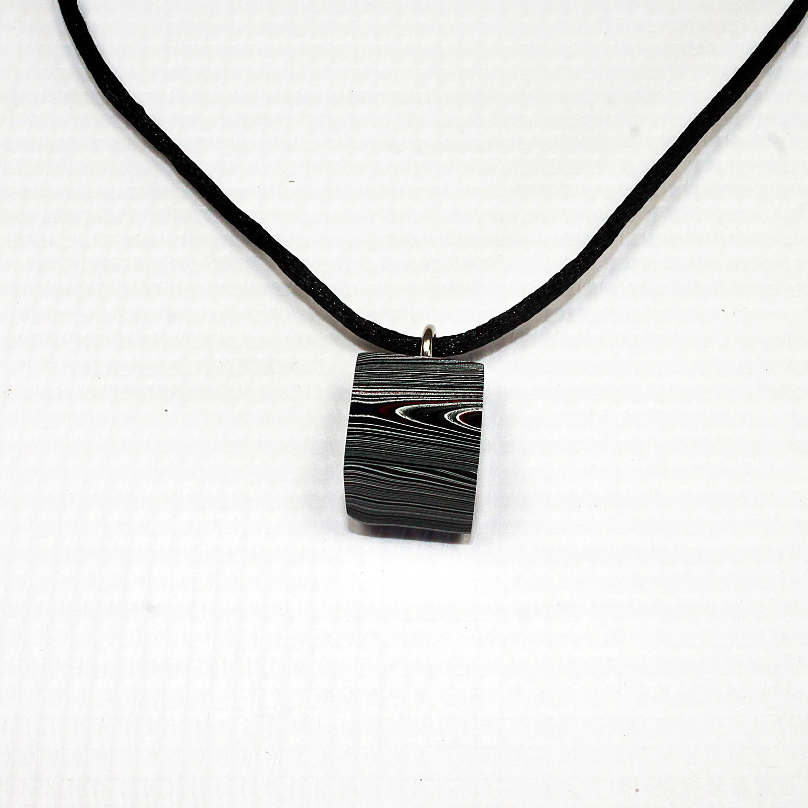 Fordite Necklace – 18.35mm x 15.2mm x 12.83mm – Black Leather Rope (N-019)