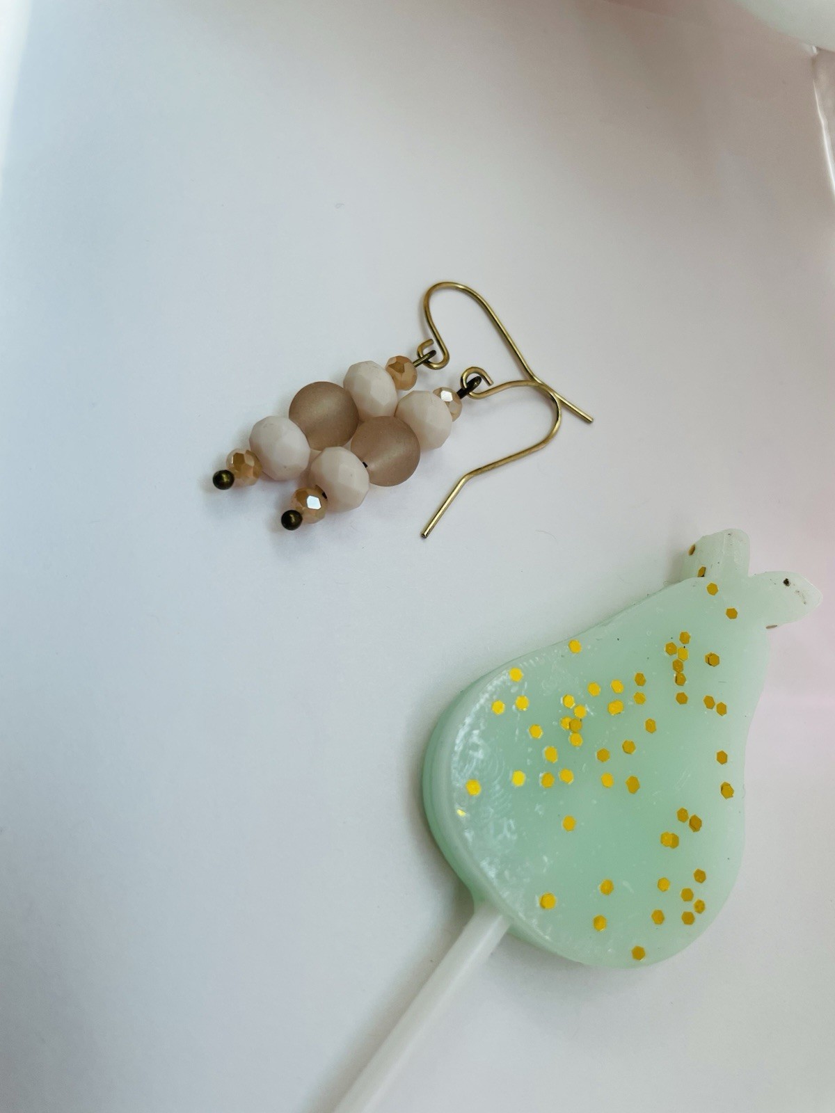 Handmade beaded dangle earrings with champagne-colored crystal and cream frosted