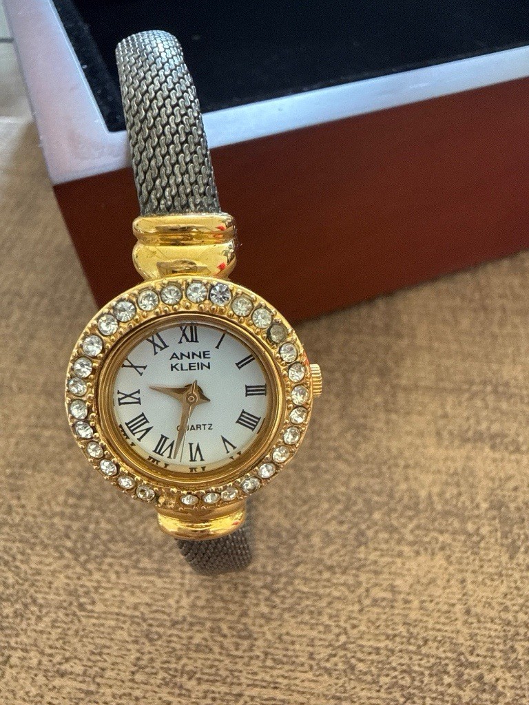Anne Klein Women’s Quartz Dress Watch Gold Case Silver Bangle White Roman Dial