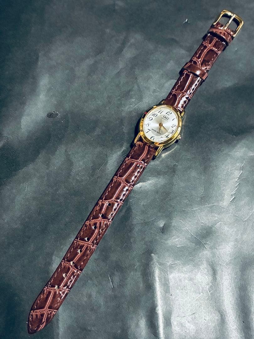 New battery. CITIZEN Q&Q gold Arabic numeral watch with brown strap.
