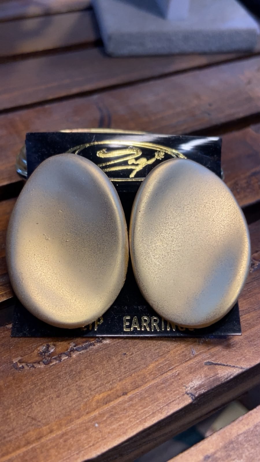 **Elegant Gold-Plated Oval Clip-On Earrings with a Satin Finish**