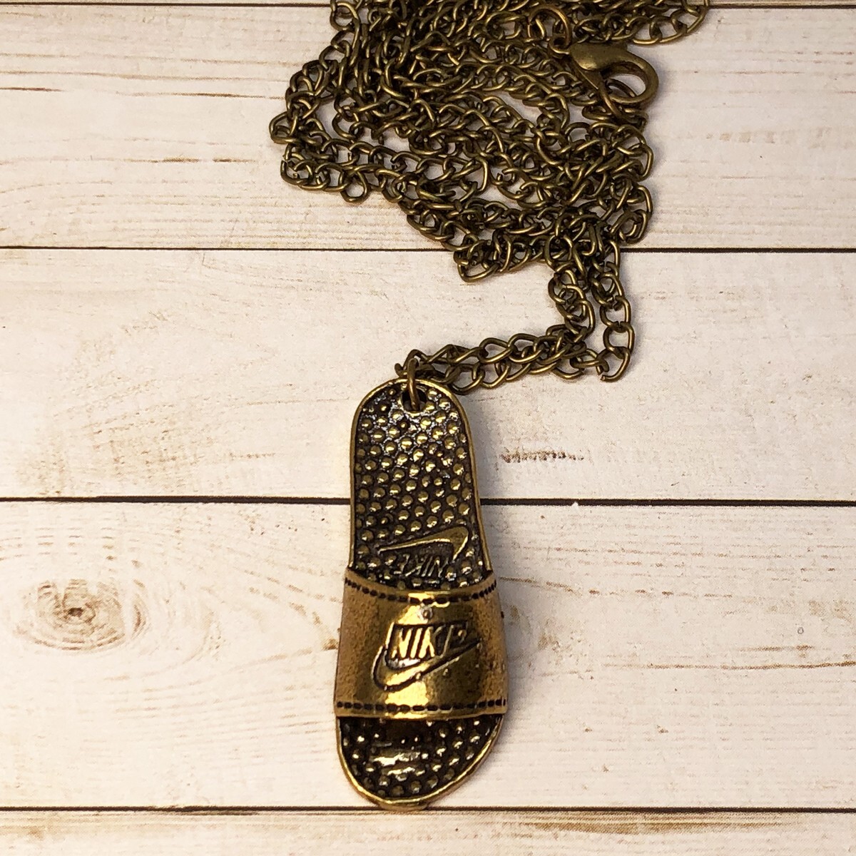 Nike Logo Slide Pendant + 20″ Necklace Antique Bronze Stainless Steel Swoosh