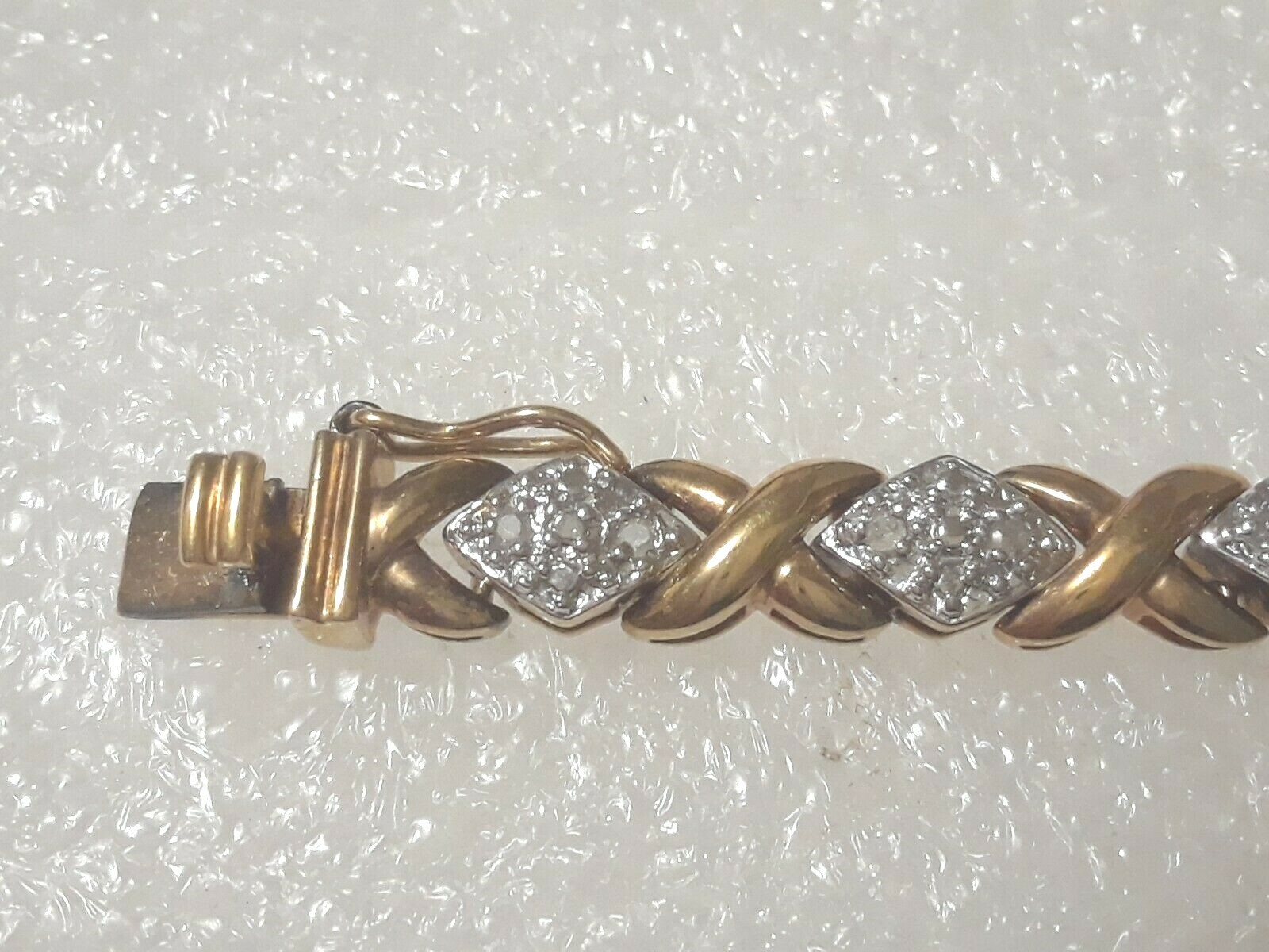 Gold tone bracelet with clear stones and safety lock clasp. 7″ long. Beautiful!