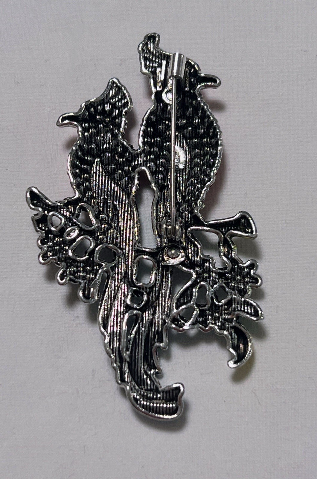 Pink rhinestone green blue enamel Birds of Paradise pin brooch sitting on flower
