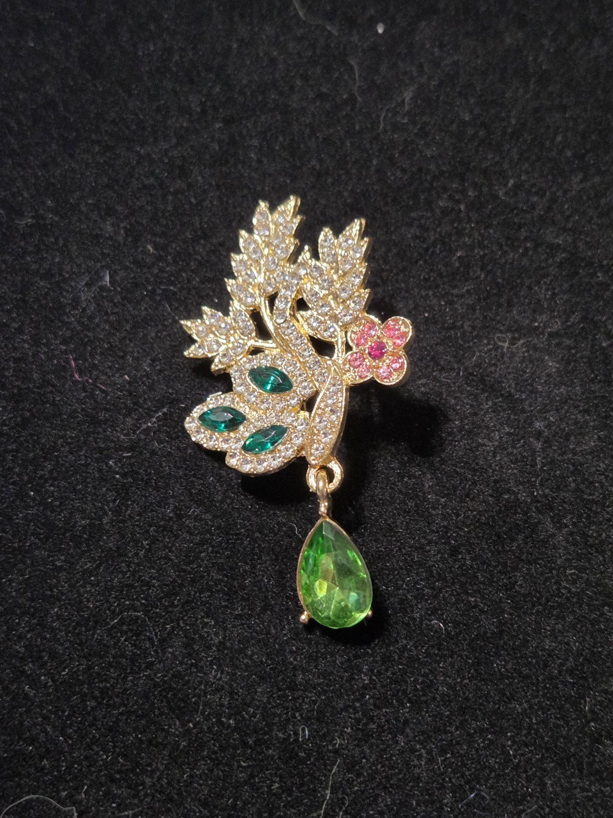 Gold tone Green and white rhinestone brooch with pink flower accent