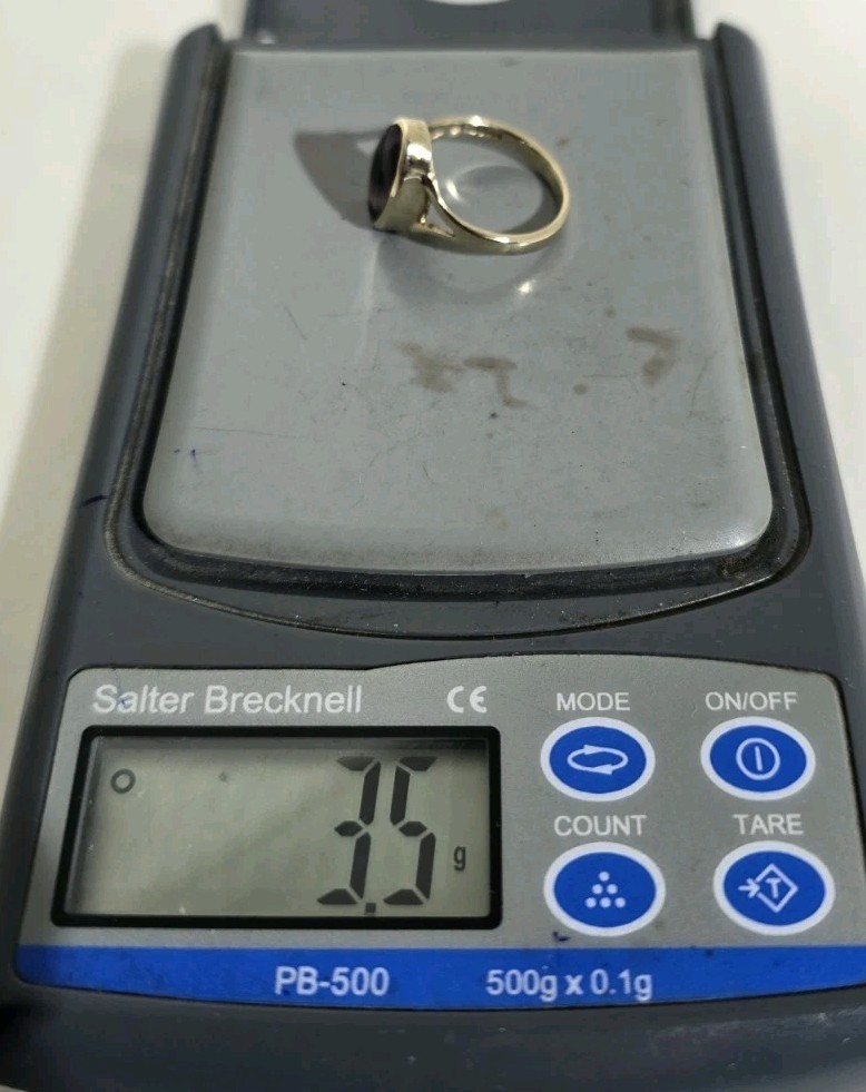 9ct Yellow gold open work ring. Collet set with an oval Blue John Cabochon.