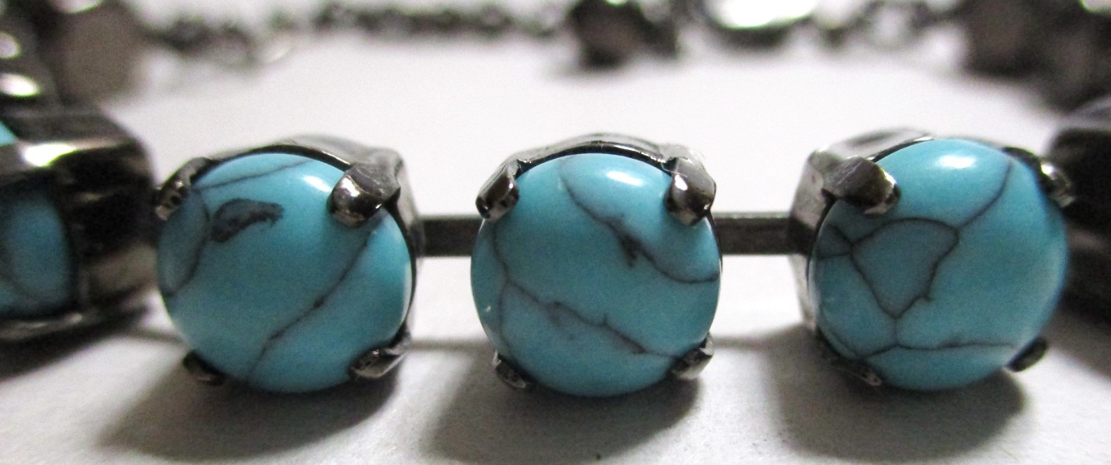 TURQUOISE BLUE HOWLITE BEADED BRACELET IN BLACK GUN METAL