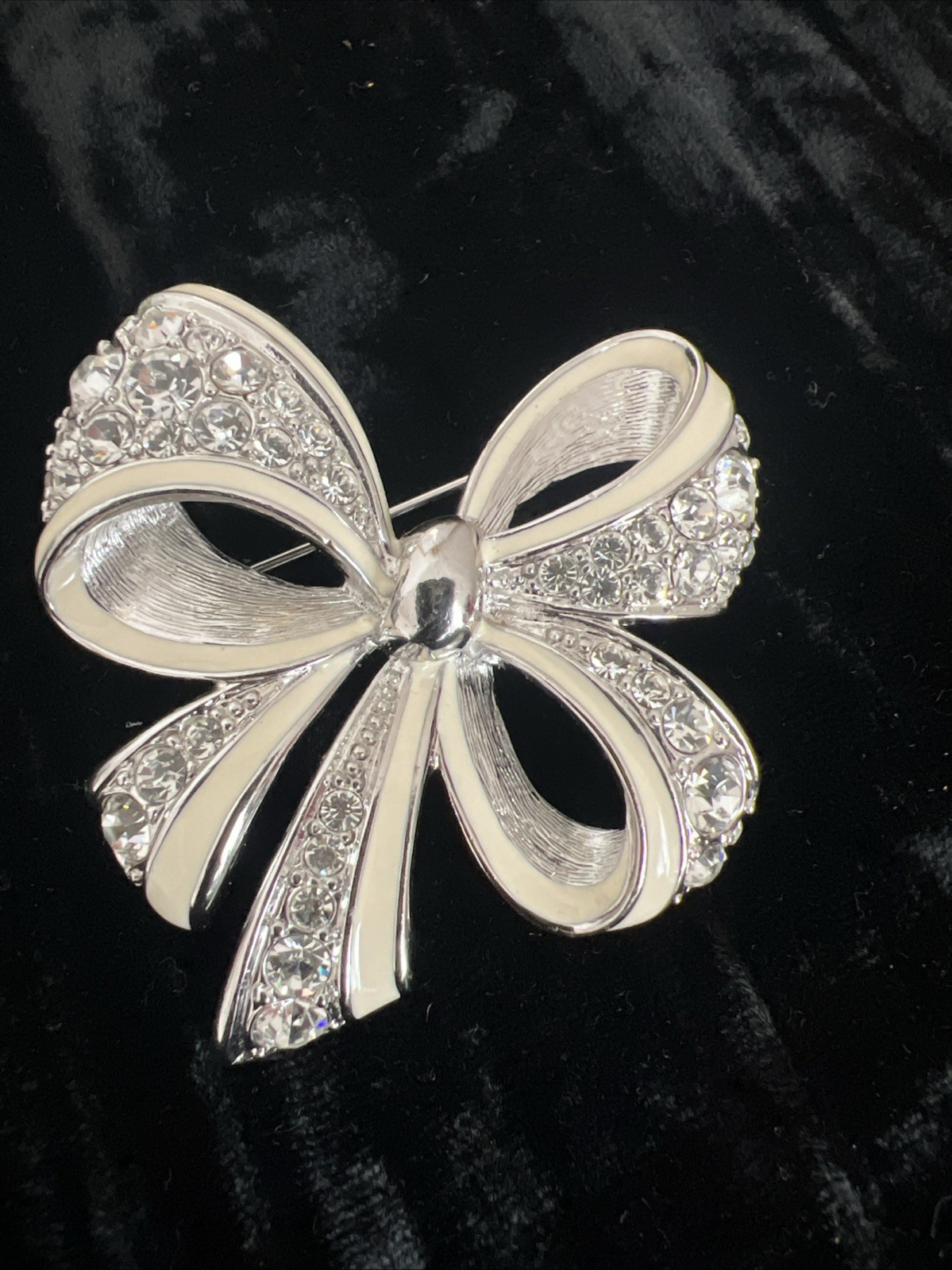 item is a Nolan Miller Shining Spirit rhinestone bow brooch from the Glamour CO.