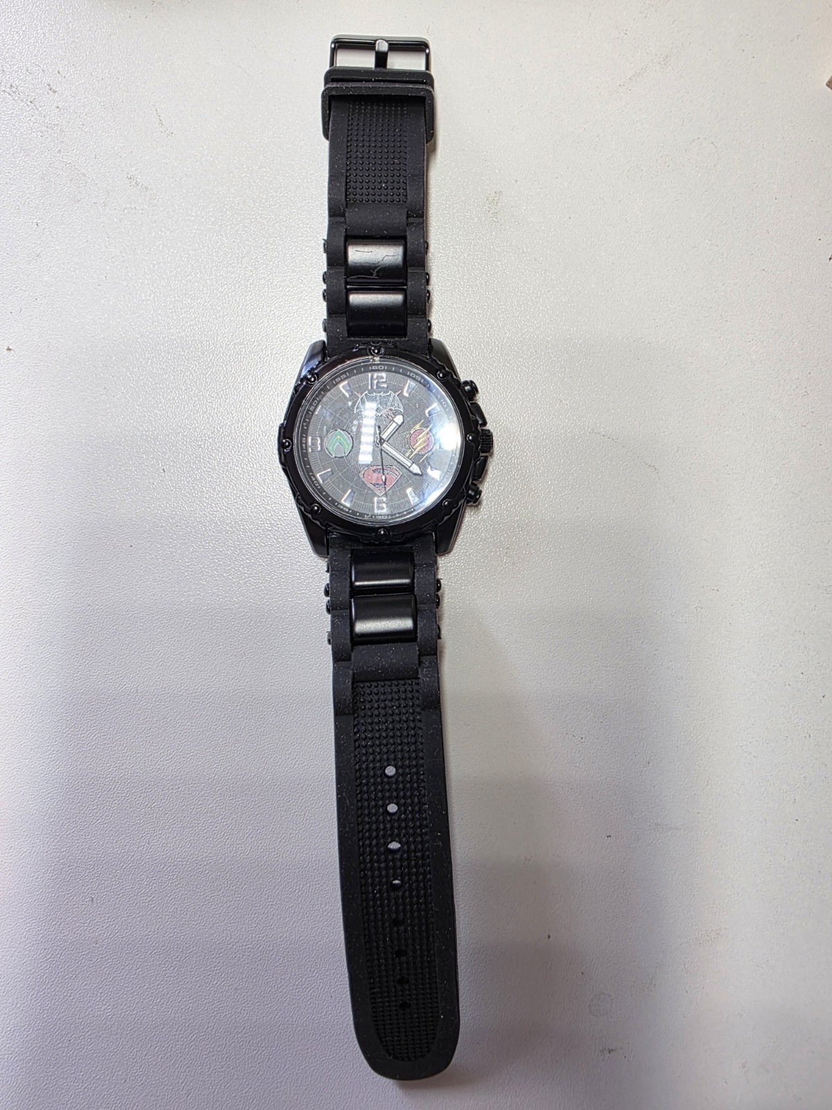 DC Justice League Men’s Quartz Analog Watch Black Silicone Band w/ Tin Case