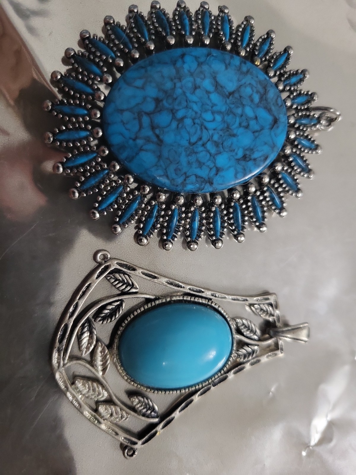 2 Faux Turquoise silvertone pendants. lg one is marked JJ both great pieces