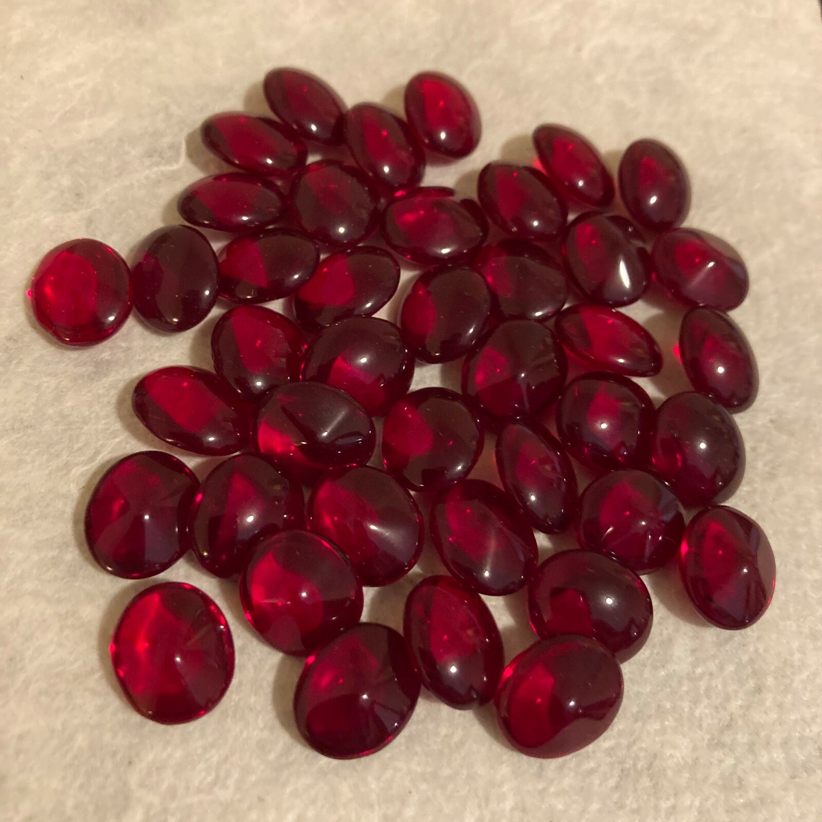 CM323 12x10mm ruby polished oval glass jewels, unfoiled pointed back (36)