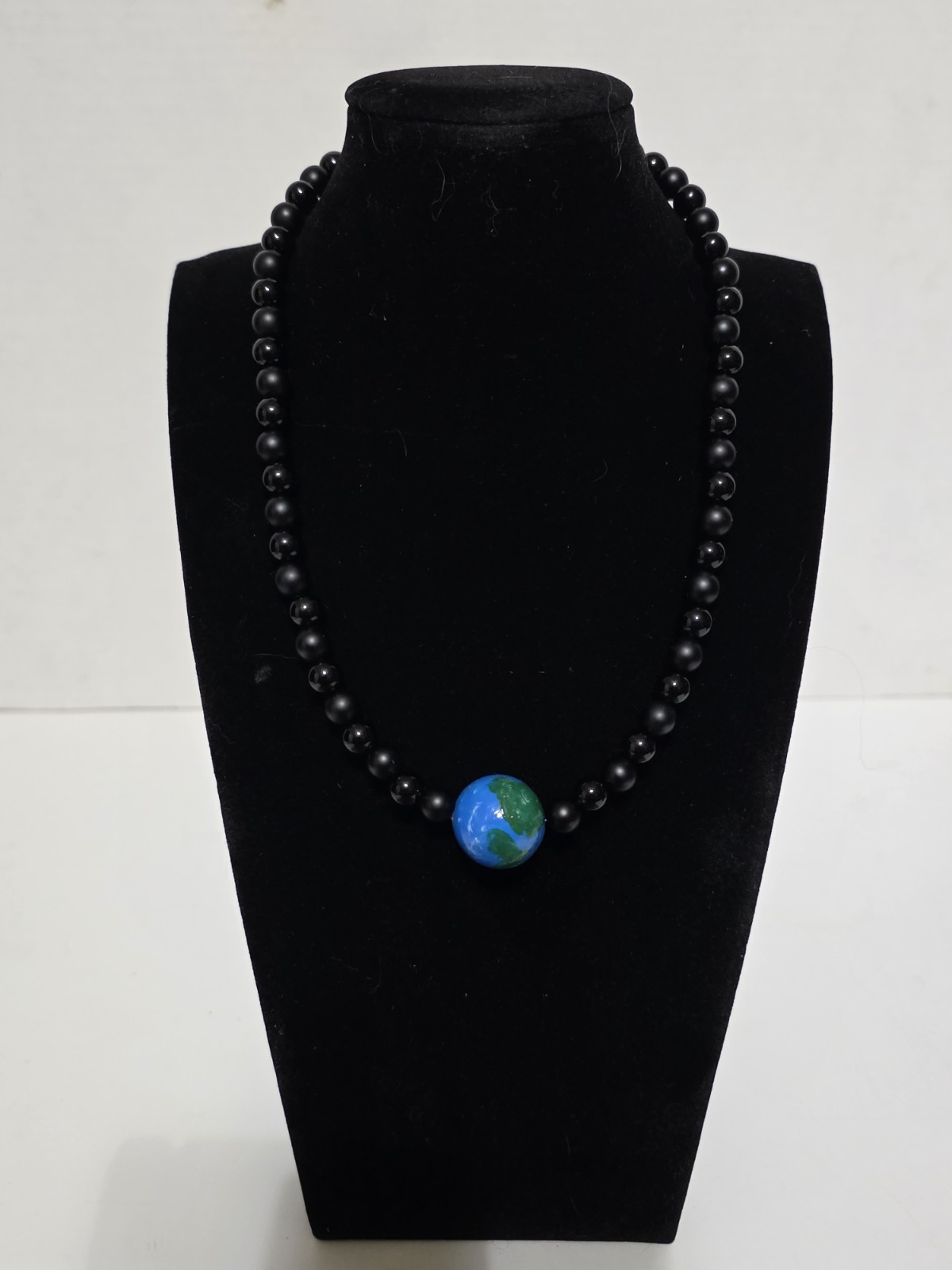 18.5in planet Earth hand painted with matte black and gloss black gemstones…