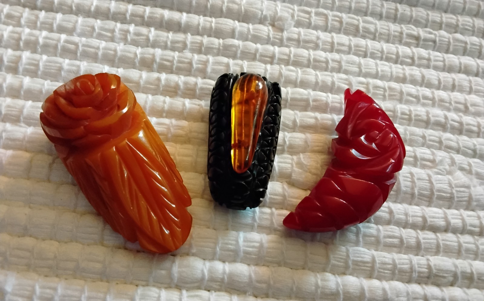 Beautiful Applejuice and black Bakelite carved dress clip