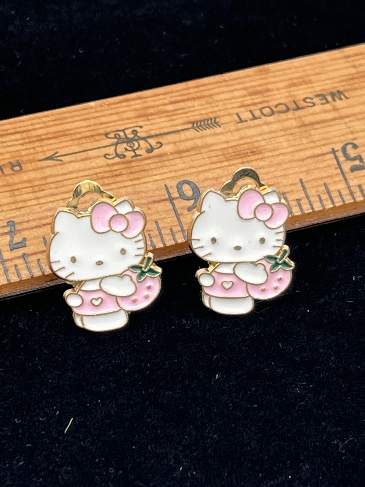 Clip on earrings with Hello Kitty holding a pink strawberry costume jewelry