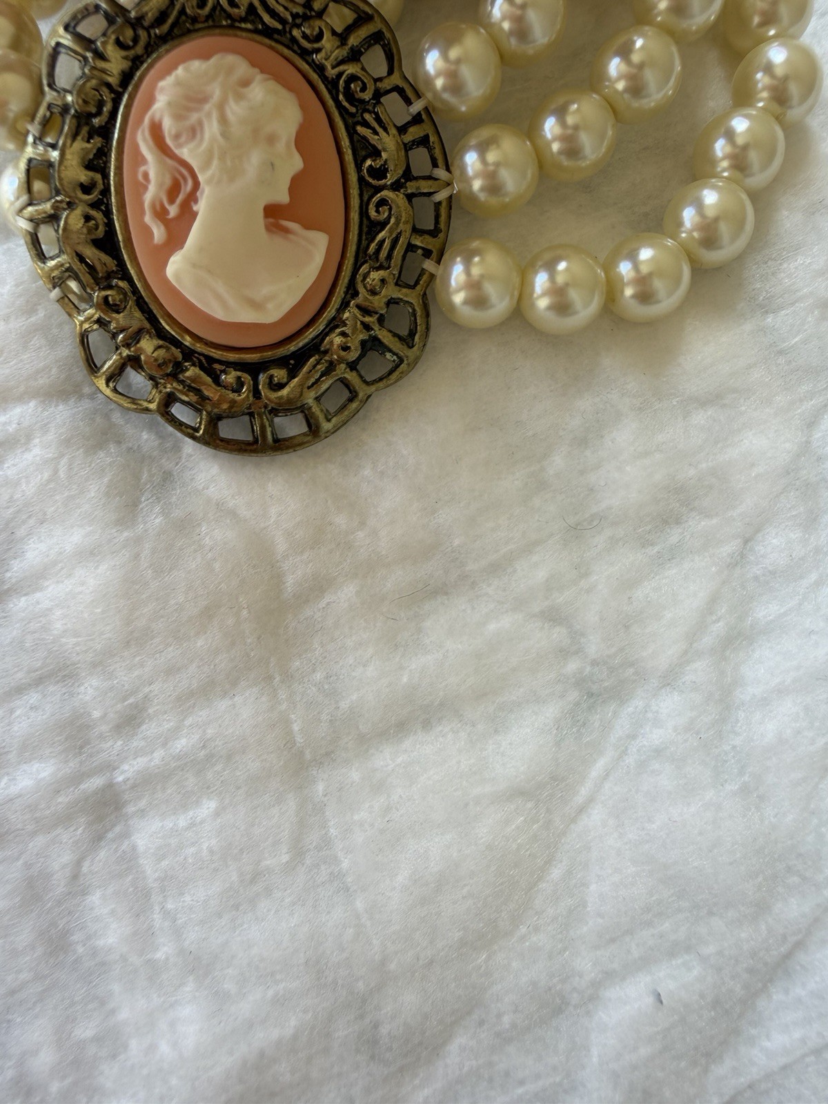Orange/coral color cameo triple strand iridescent faux pearl stretch bracelet