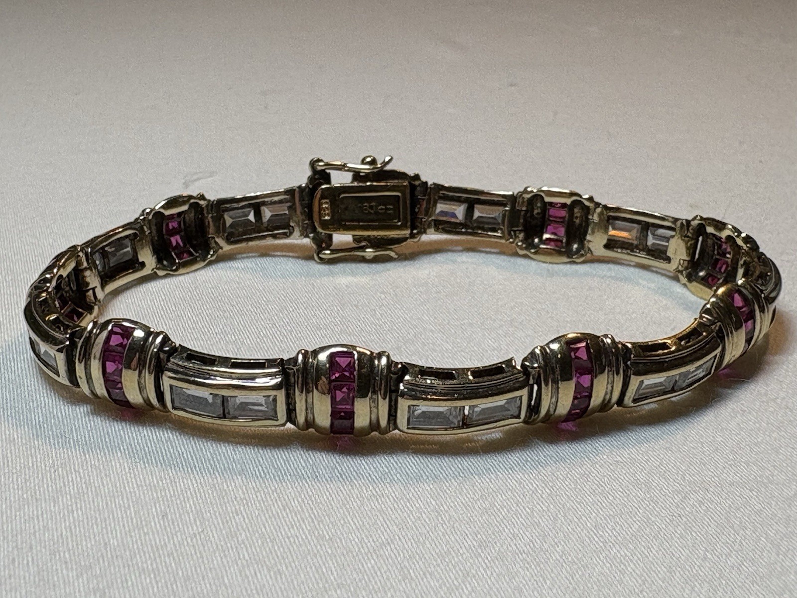 A sterling silver bracelet featuring baguette and round cubic zirconia stones.