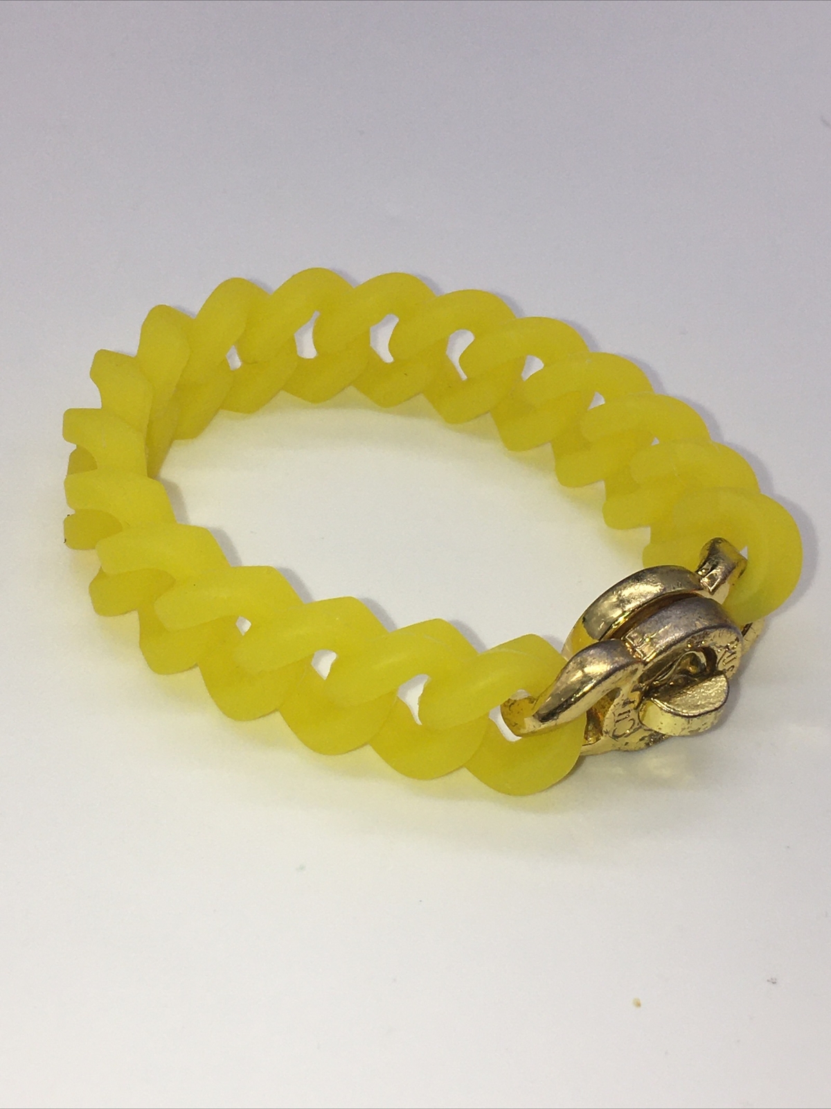 Rustic Cuff Gold Tone Logo Turn Lock Yellow Silicone Stretch Bracelet