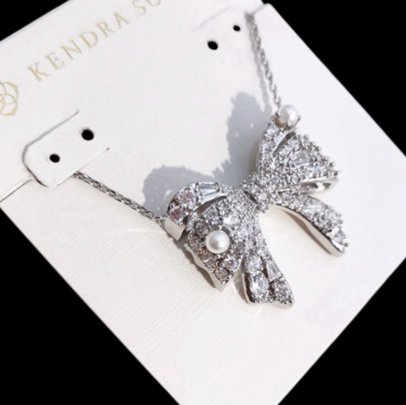 New Krista Silver Bow Short Pendant Necklace in White Mix on Kendra Scott Card