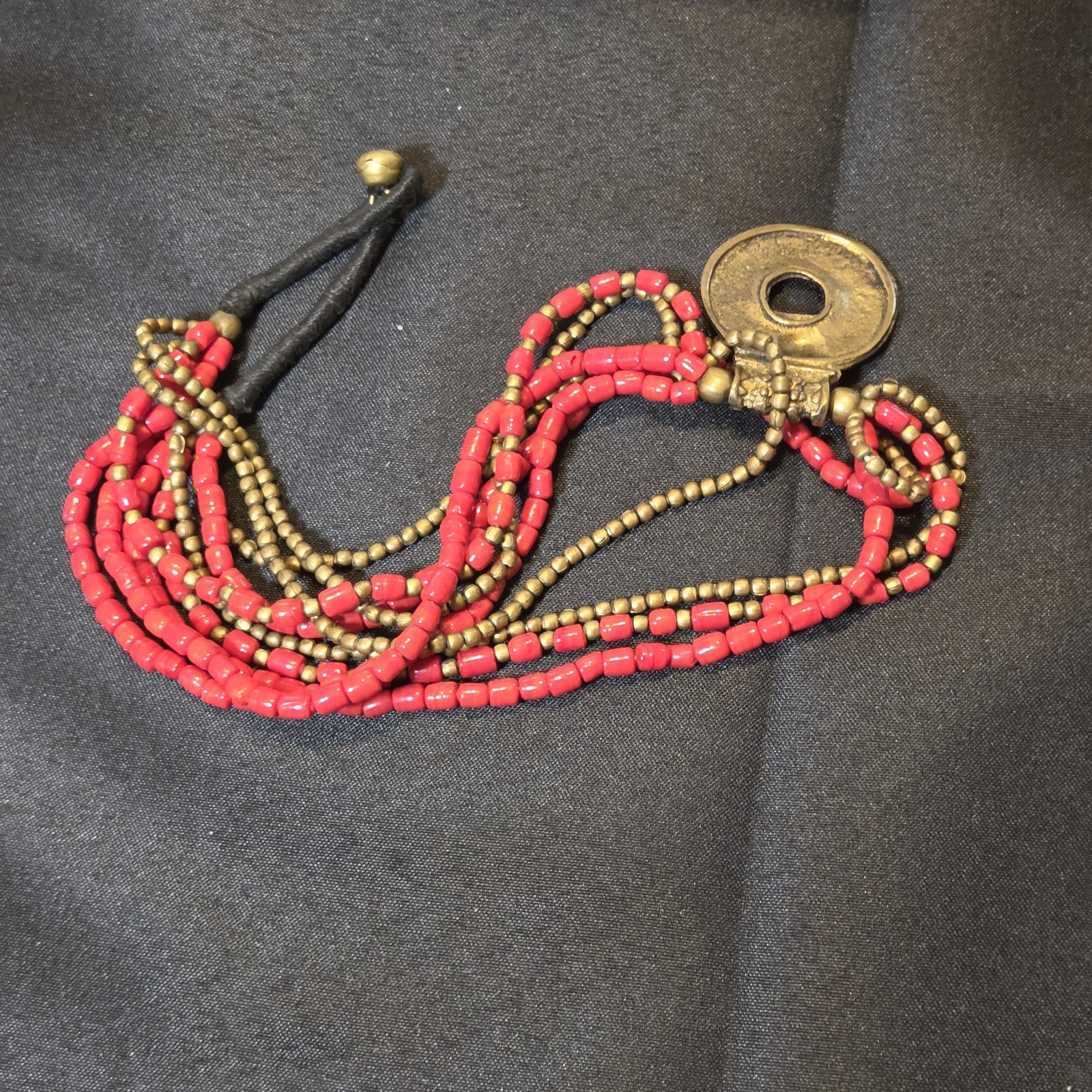 Red Beaded Multi-strand Necklace With Antique Brass Pendant.