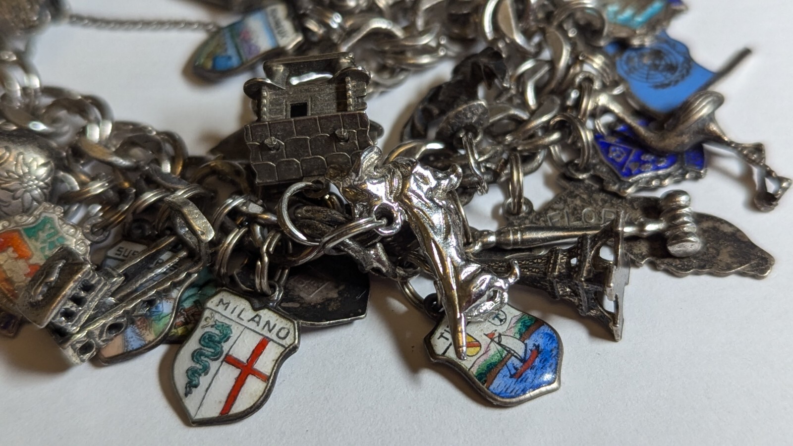 VINTAGE STERLING SILVER CHARM BRACELET WITH ABOUT 35 CHARMS WEIGHS 94.4 GRAMS