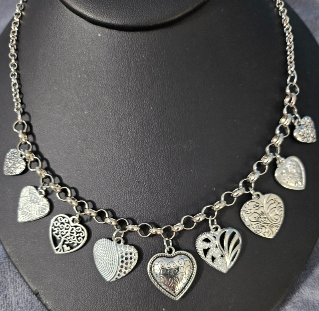 Heart Charm Necklace Silver Tone 16 in with 3 in extender. 9 different charms.
