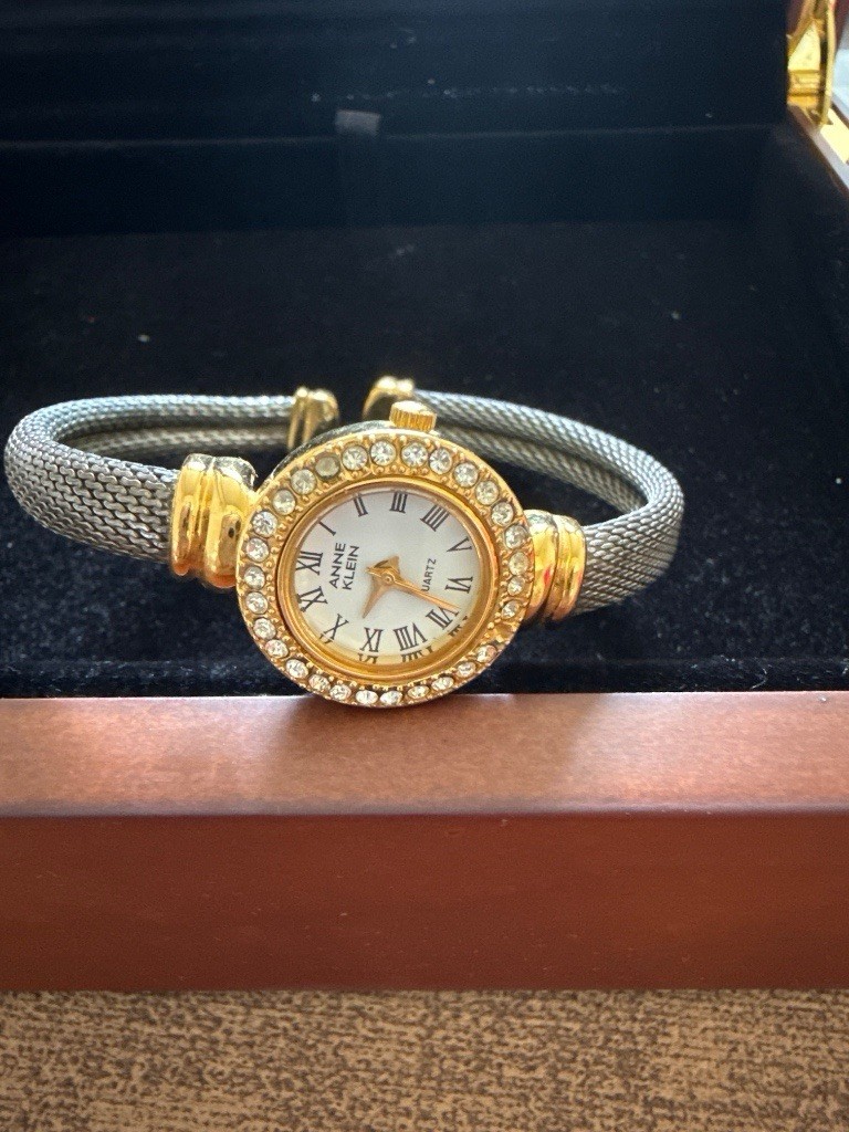 Anne Klein Women’s Quartz Dress Watch Gold Case Silver Bangle White Roman Dial