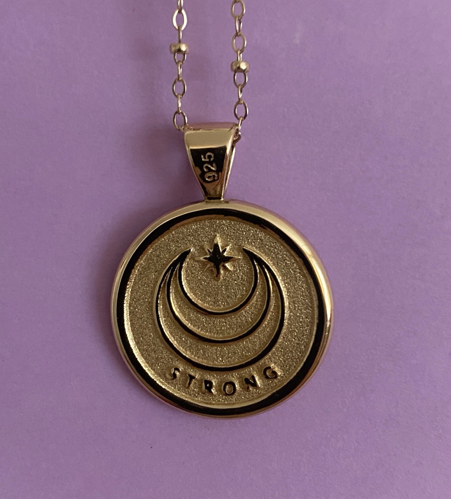 Jane Win Small “Strong” pendant with bead chain.