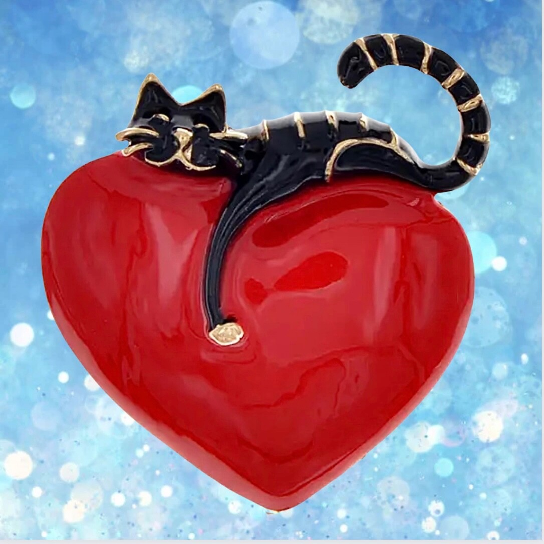 Rich red, shiny heart with comfy cat resting on top. Puffed up. Pin, brooch.