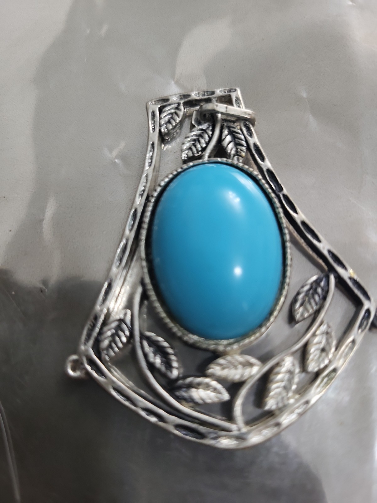 2 Faux Turquoise silvertone pendants. lg one is marked JJ both great pieces