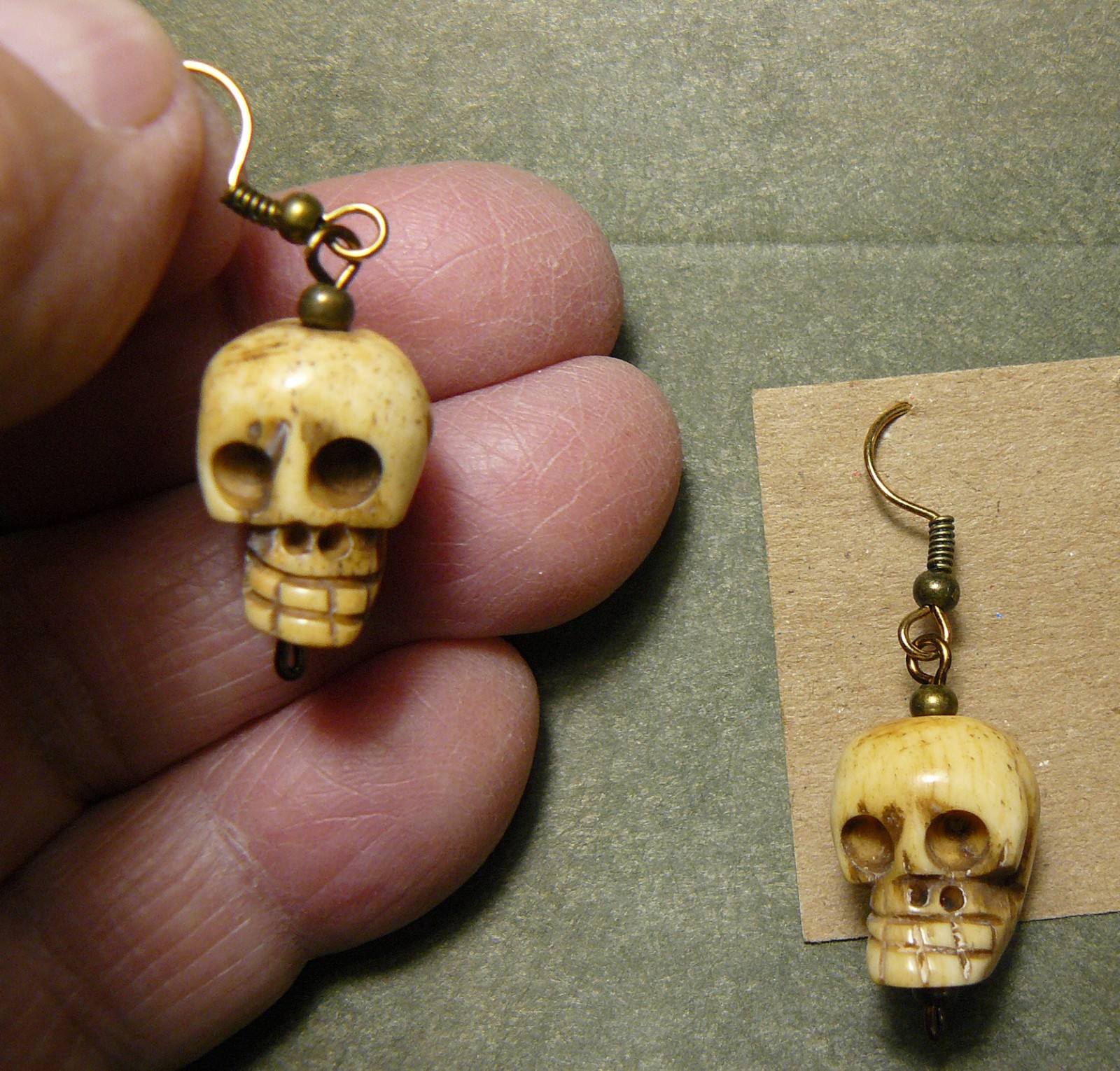 PAIR OF SKULL EARRINGS_REALISTICLY CARVED WATER BUFFALO BONE_THAILAND_262418-01