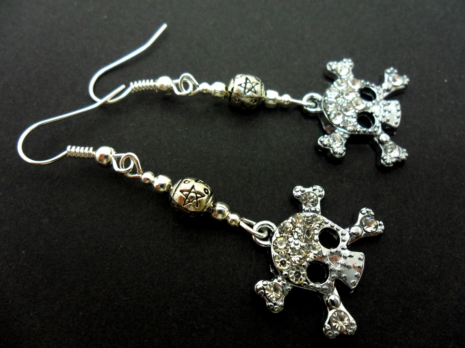 A PAIR CUTE DIAMANTE RHINESTONE DANGLY SKULL EARRINGS.