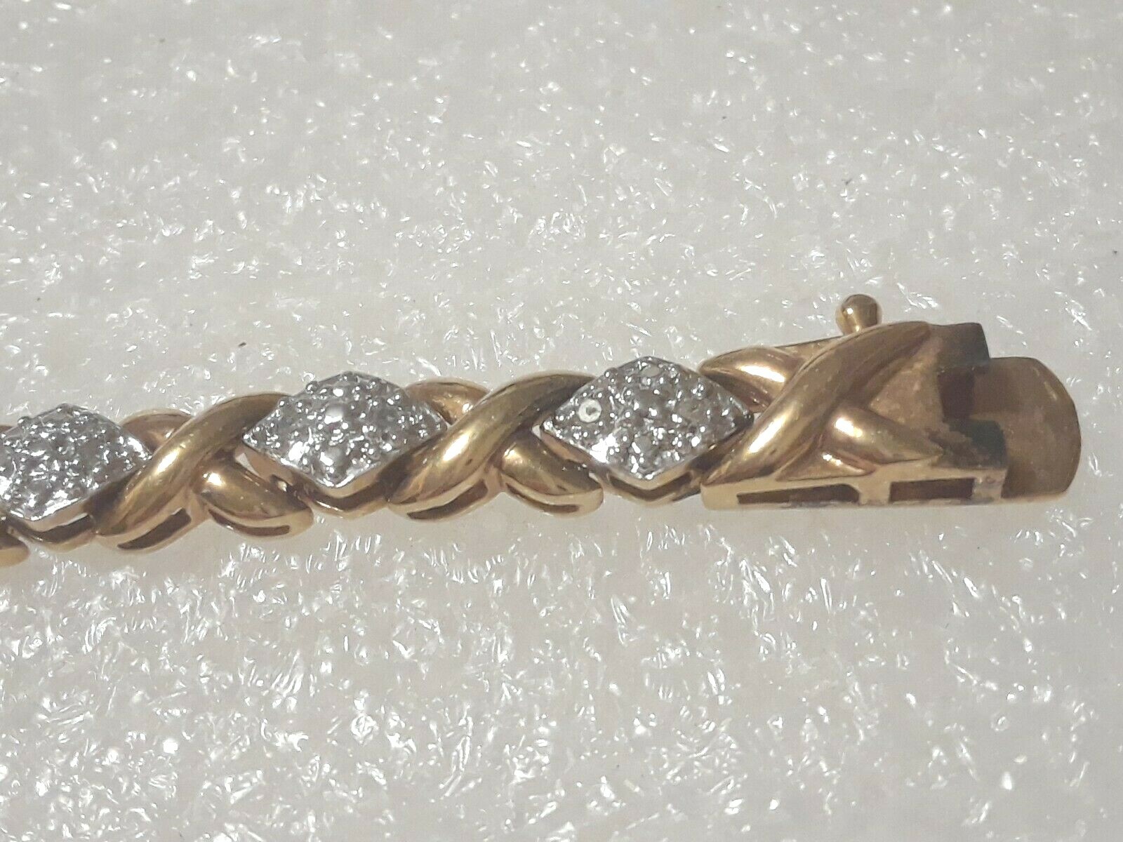 Gold tone bracelet with clear stones and safety lock clasp. 7″ long. Beautiful!