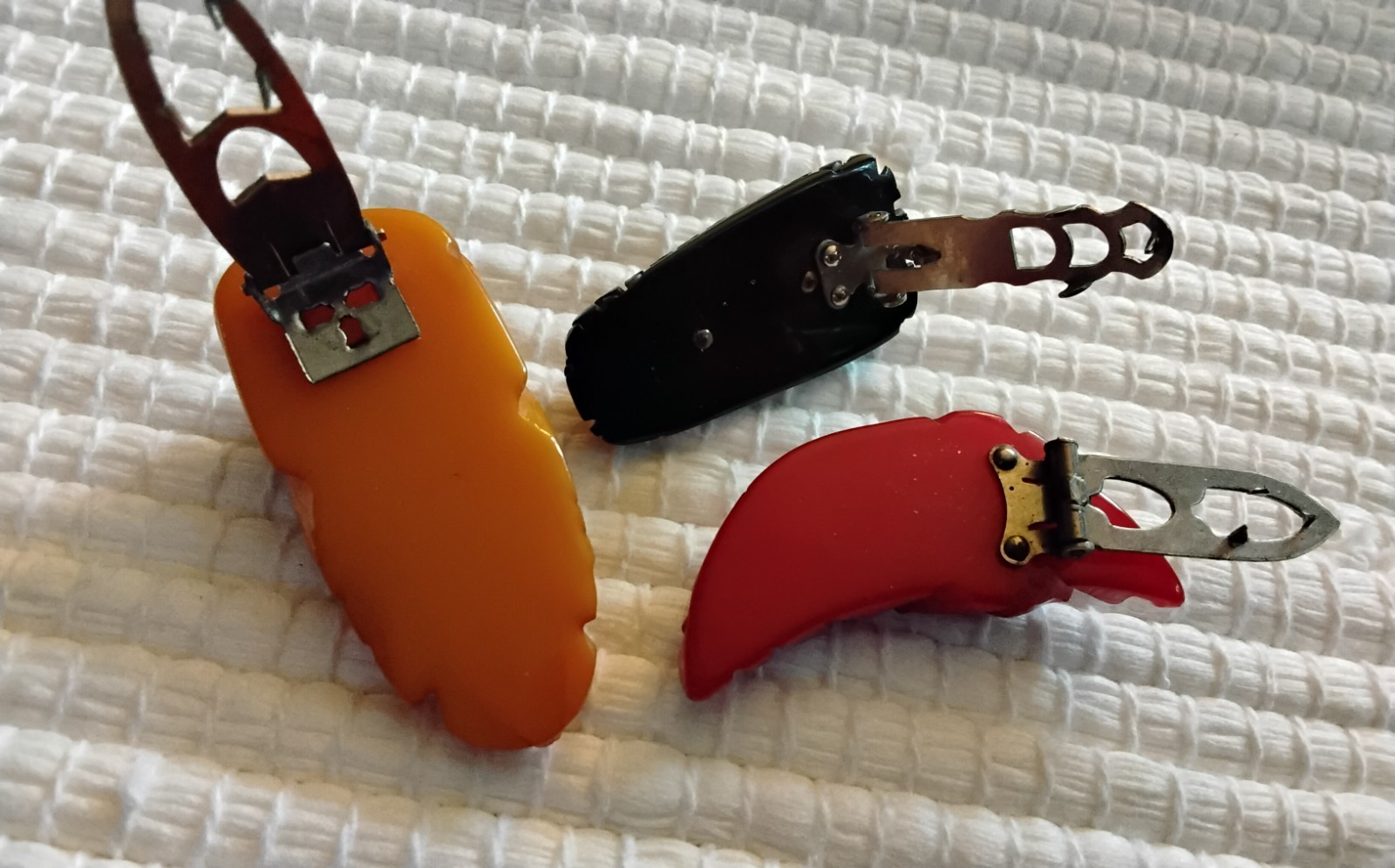 Beautiful Applejuice and black Bakelite carved dress clip