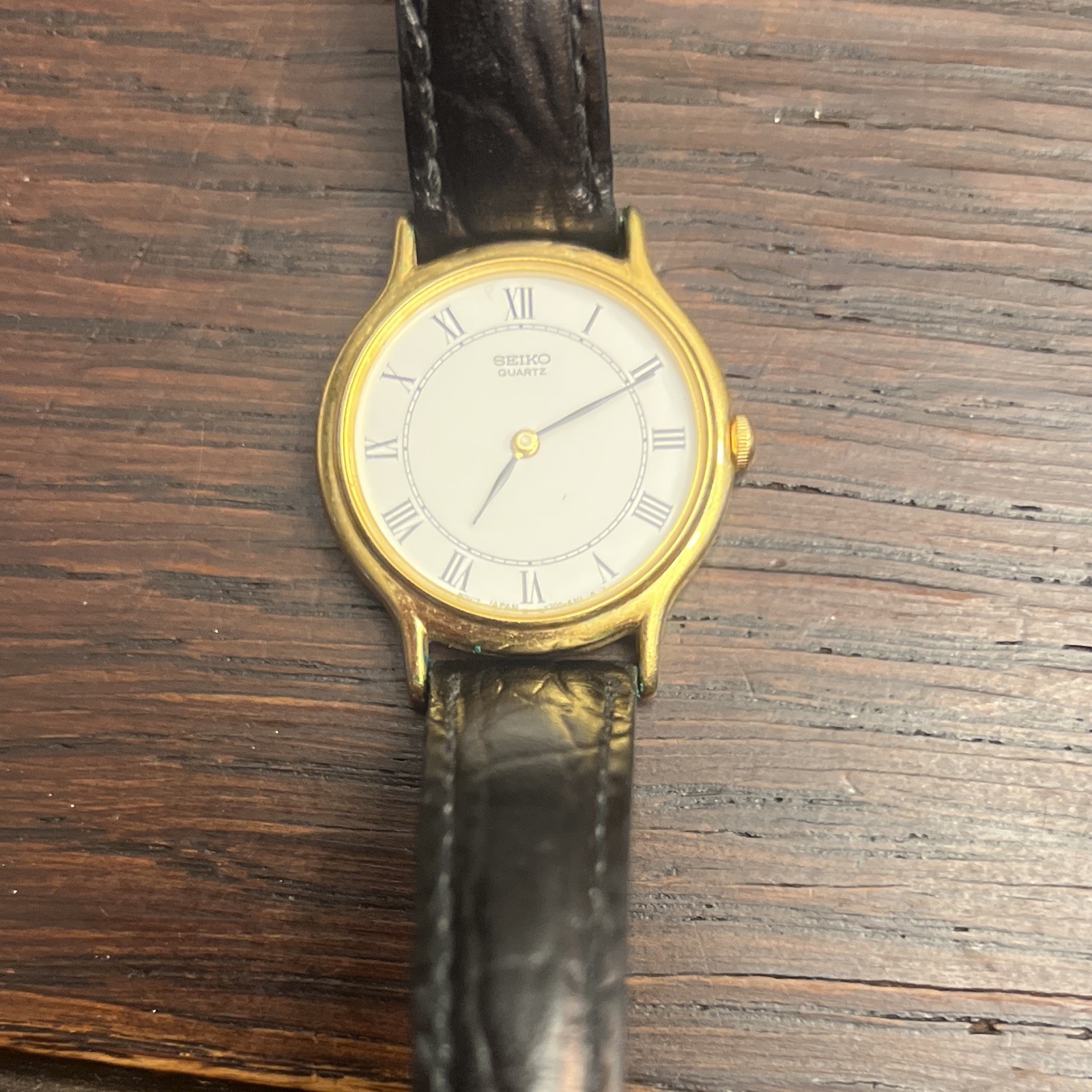 Seiko Women’s Vintage Quartz Gold Tone Case White Roman Dial Black Leather Strap