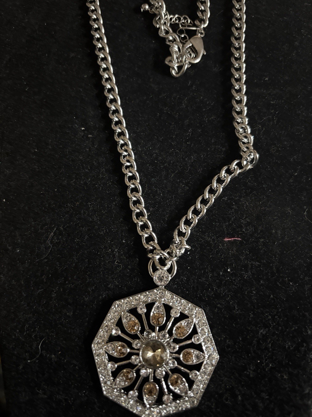 Chicos Elegant silver-tone pendant necklace featuring a brown crystal center