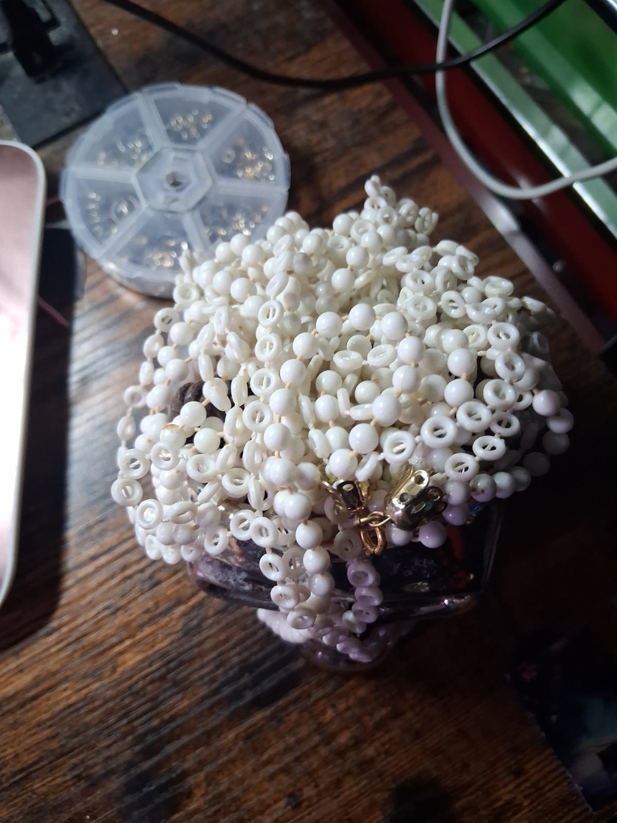 Skull Head With about 6 Pieces Of Jewelry With A White Necklace On Top