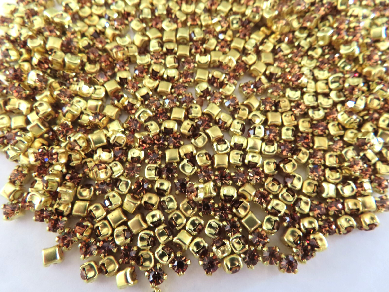 720 Swarovski Rhinestones 24pp Light Smoked topaz/brass settings.