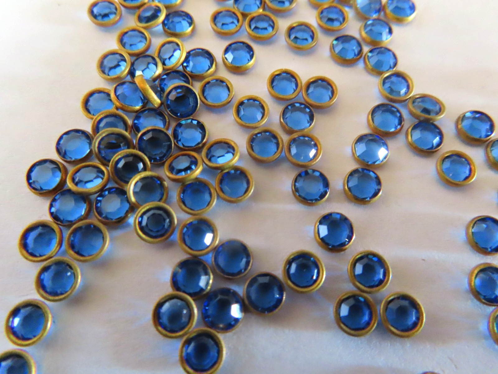 144 Swarovski Channel Rhinestones 32pp Sapphire/Brass settings.